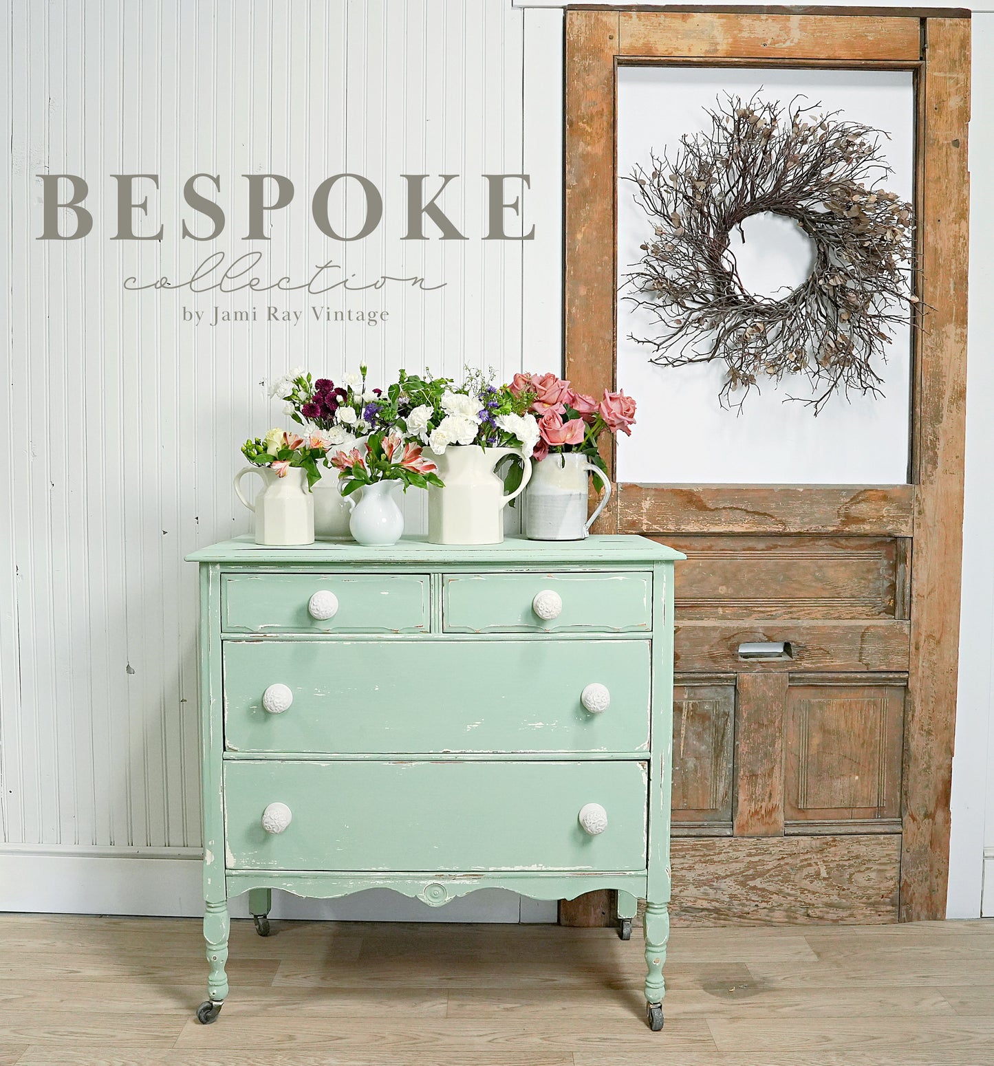 A green vintage dresser painted with milk paint, featuring white knobs, set against a rustic background with a 'Bespoke' sign and decorative items.