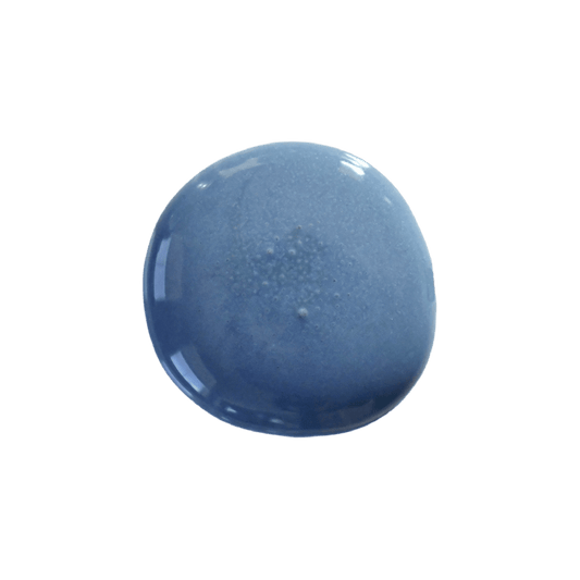 A dollop of milk paint in the color Denim, up against a transparent background.