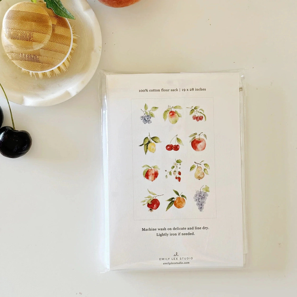 Packaged product with fruit illustrations on a white surface