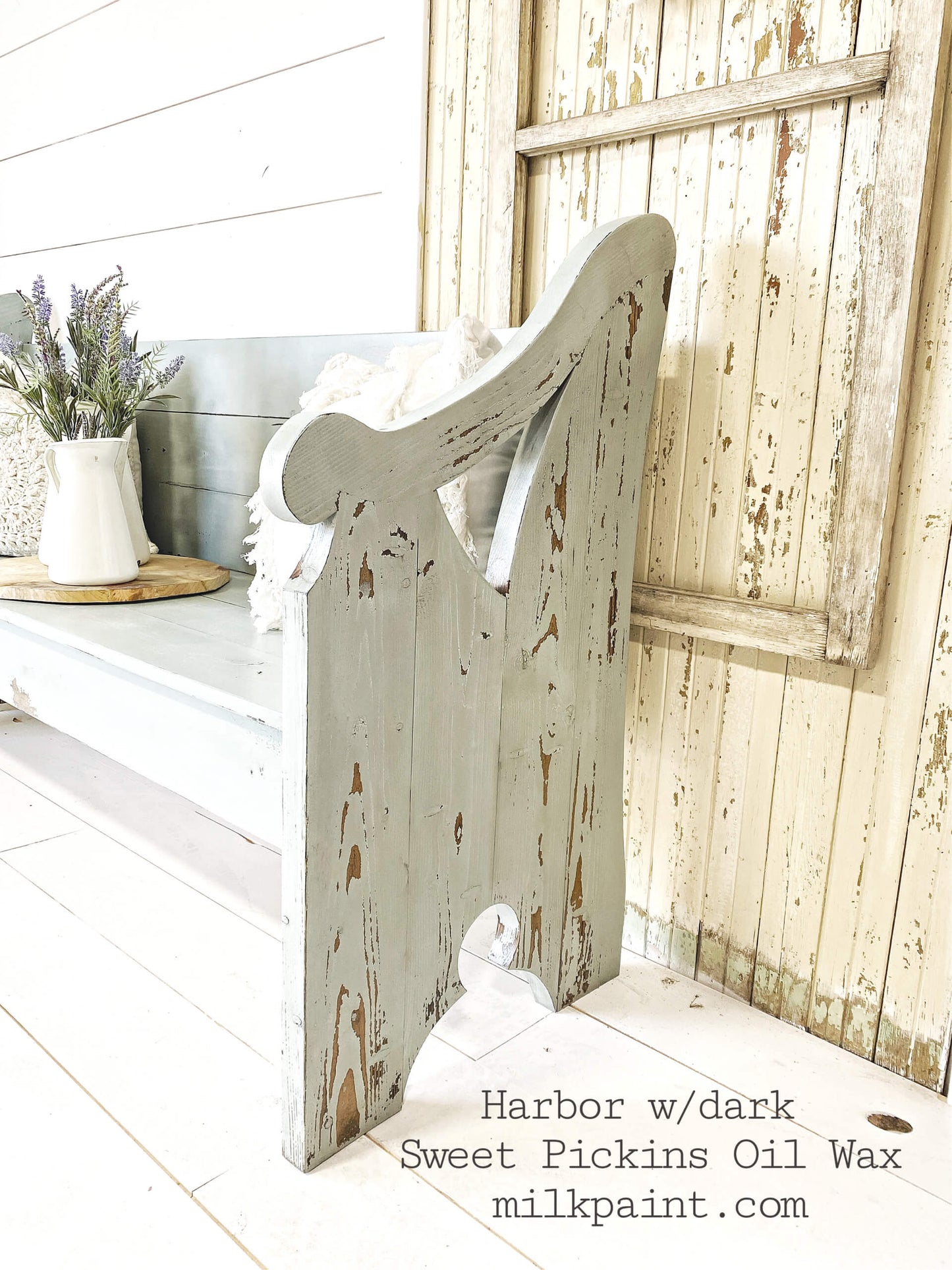 Wooden bookend, painted in blue-gray shade Harbor from Sweet Pickins, with rustic design against a wooden wall.
