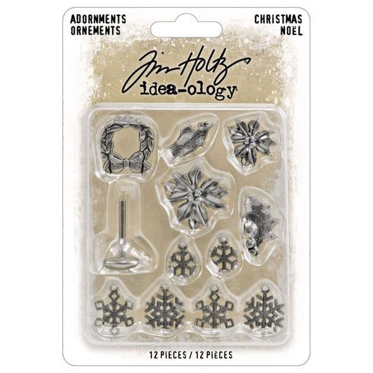Packaged set of Christmas-themed metal embellishments with Tim Holtz branding on a beige background.