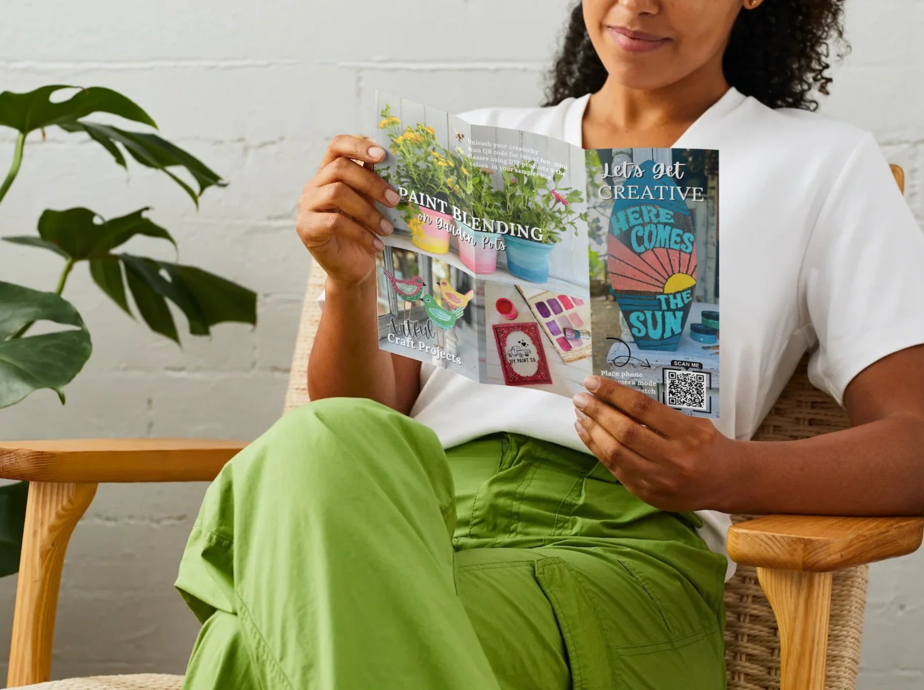 Person holding a colorful book titled 'Paint Blending Here Comes The Sun' in a casual setting.