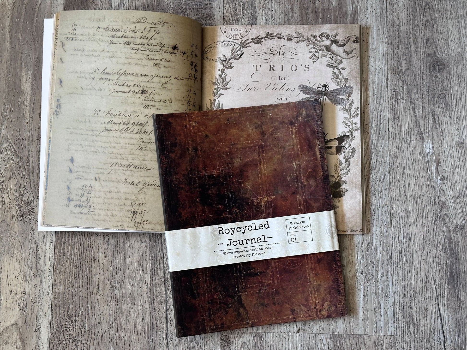 Brown Roycycled brand journal with a label on a wooden surface