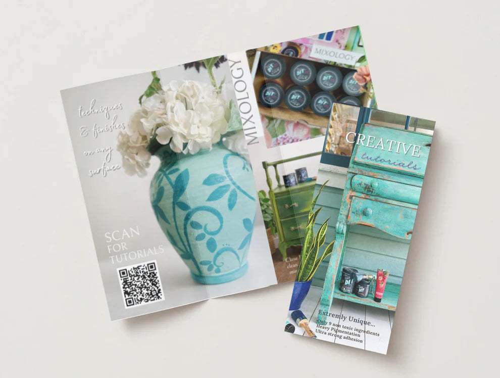 Three colorful brochures on a white surface with floral and interior design elements.