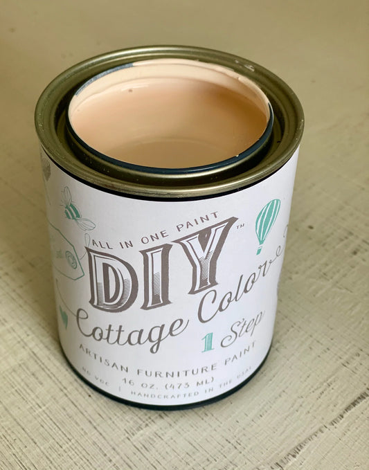 An open can of chalk paint in a pink color called "Vintage Pink"