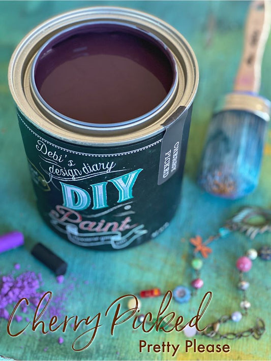 An open can of cherry red milk paint titled "Cherry Picked" from "DIY Paint Co."
