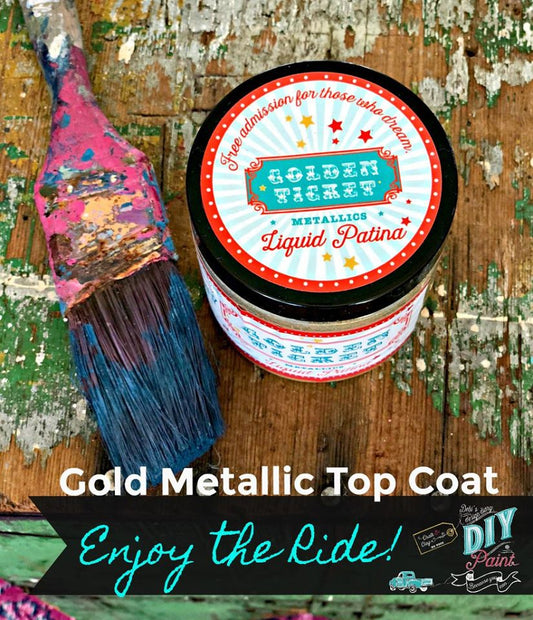 A container of DIY Paint Co. liquid patina with a label that reads 'Golden Ticket Metallic Liquid Patina', accompanied by a paintbrush on a wooden surface.