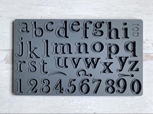 The mould "Harper" from IOD, showing the whole alphabet and 10 numbers. The mould is sitting on a white table.