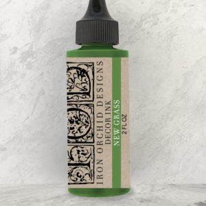 A bottle of green ink from Iron Orchid Designs with the name "New Grass"