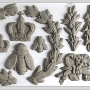 A variety of clay castings from IOD's "Laurel" mould, showing bees, crown, and fronds.
