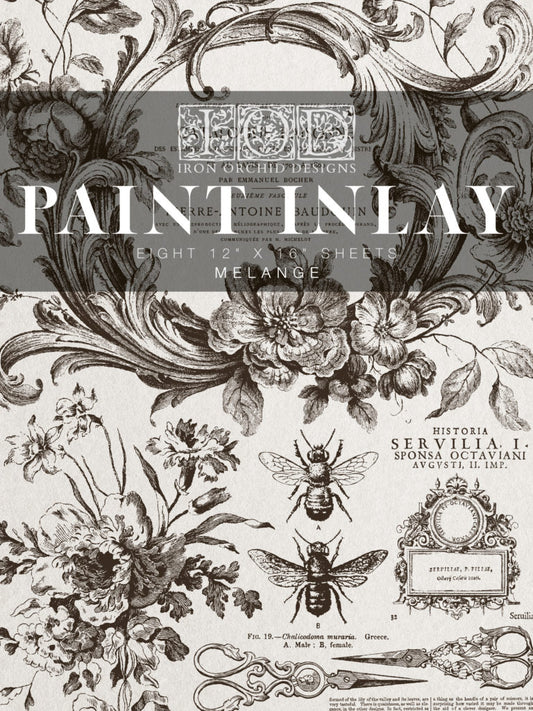 A package of IOD Melange pattern paint inlay sheets with illustrations of flowers, bees, and vintage decorative elements.