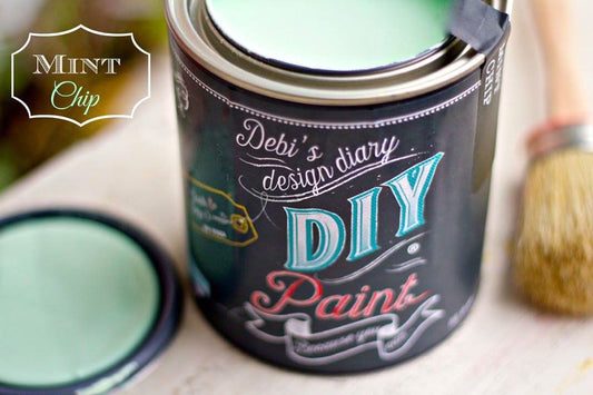 A can of Mint Chip DIY paint with a brush and a sample swatch shown in front of it.