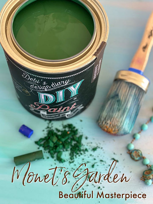 An open can of "DIY Paint Co." brand chalk paint in a green color, with a brush and paintbrushes lying next to it