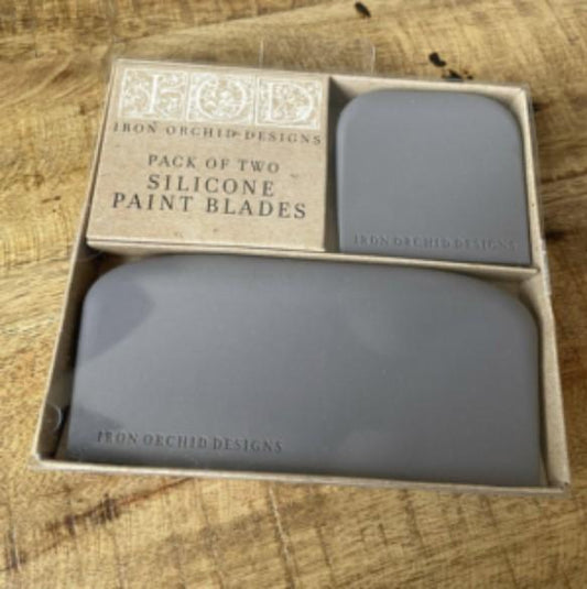 Two silicone paint blades packaged in a cardboard box with the brand name 'Iron Orchid Designs' visible on the packaging.