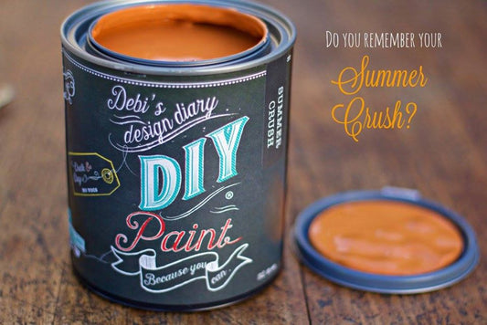An open can of orange paint called "Summer Crush" from the brand DIY Paint Co.