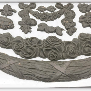 A collection of decorative clay castings of swags and floral arrangements, created by Swags by IOD.