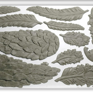 A selection of clay castings featuring various feather and wing designs, primarily in grey color.