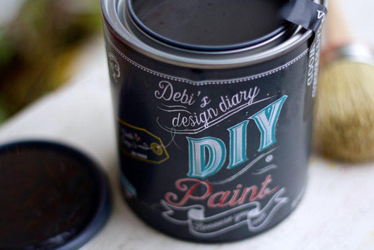 An open can of black chalk paint in the shade "Black Velvet"