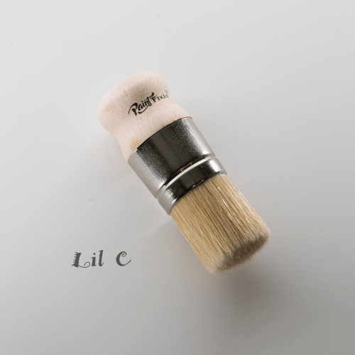 A stencil and wax brush with a large wooden knob handle, branded with 'Lil C' on the handle.