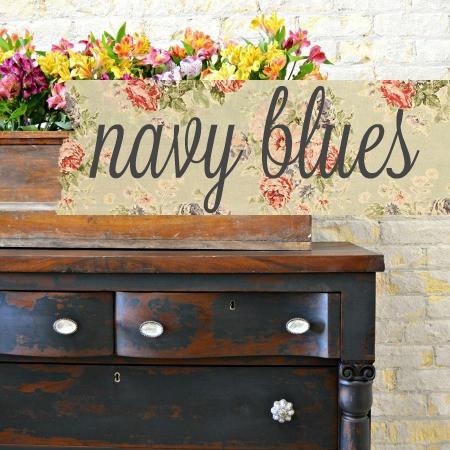 A dresser milk painted navy using the color "Navy Blues", with the word "Navy Blues" over top the painted dresser.
