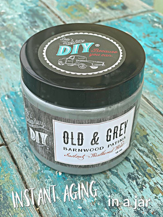 A jar labeled 'Old & Grey Liquid Patina' with text indicating it's for instant aging in a jar, placed on a wooden surface.
